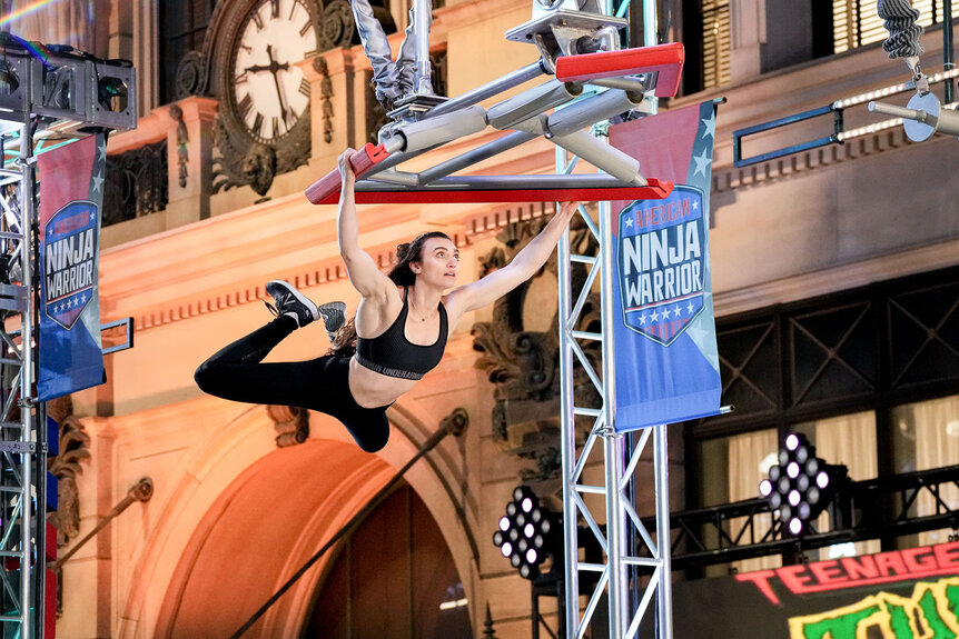 Ashley Bergstrom swings while completing the American Ninja Warrior Season 15 obstacle course