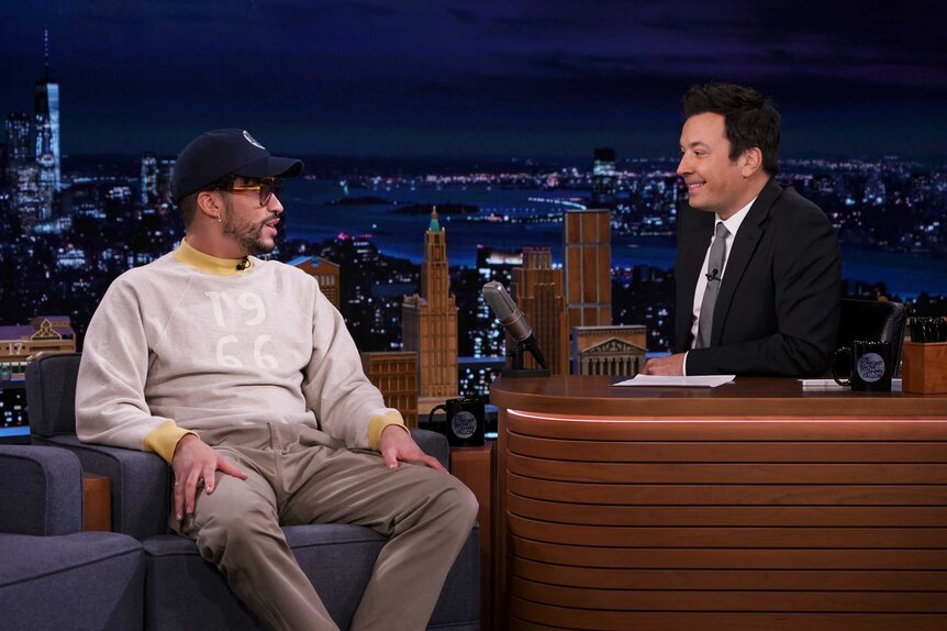 Bad Bunny appears next to Jimmy Fallon on The Tonight Show.