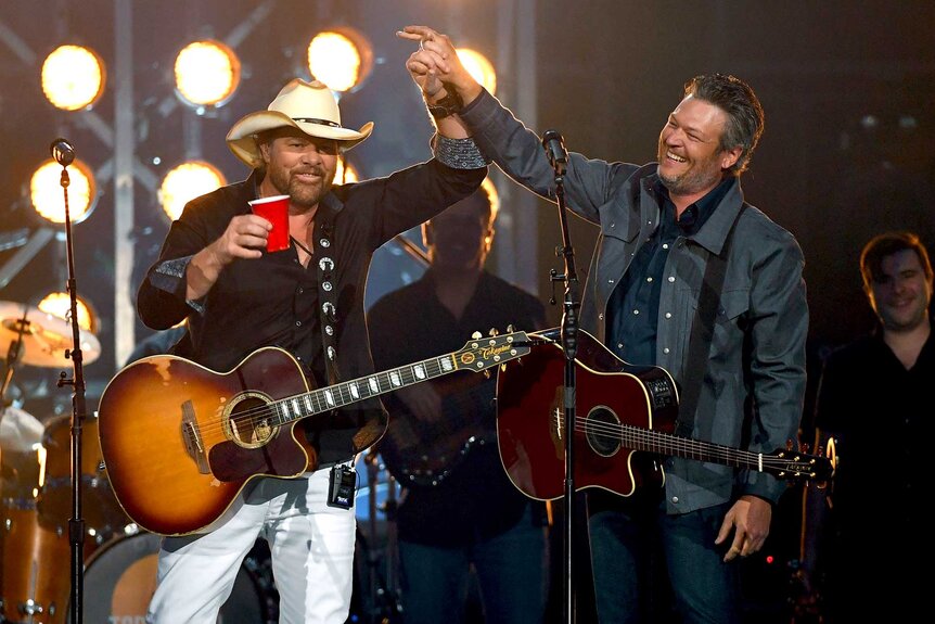 Toby Keith and Blake Shelton performing on stage.
