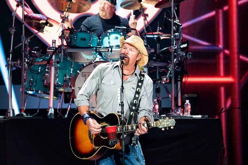 Toby Keith performing on stage.