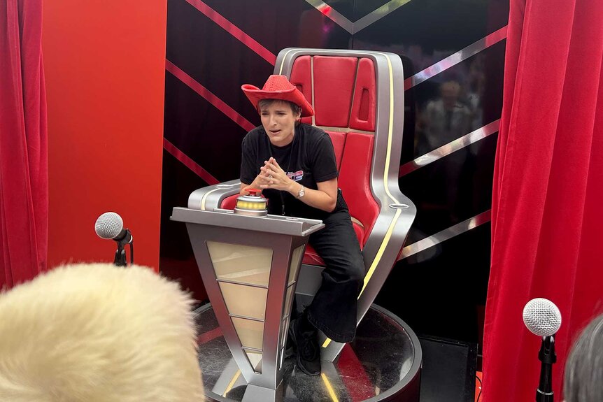 A fan sits in a chair during San Diego Comic-Con 2023