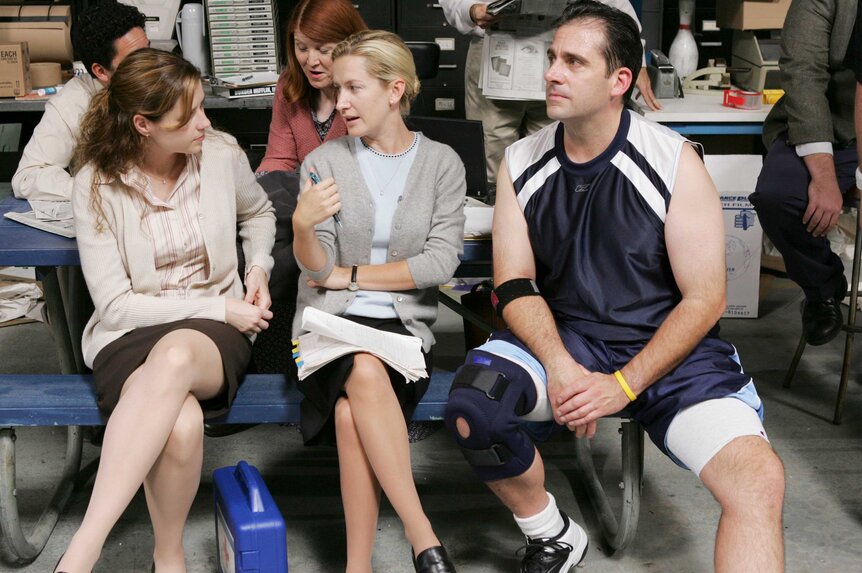 Pam Beesly, Angela Martin, and Michael Scott sitting together.
