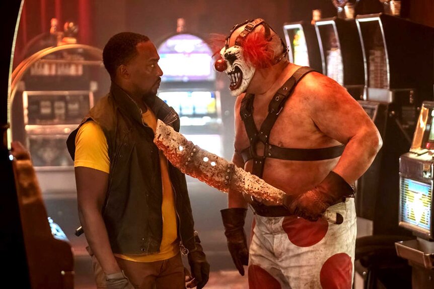 Characters John Doe and Sweet Tooth appear in a scene from Twisted Metal.