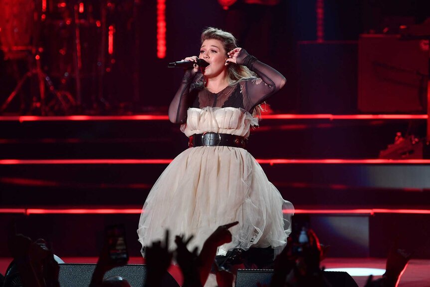 Kelly Clarkson performing on stage.