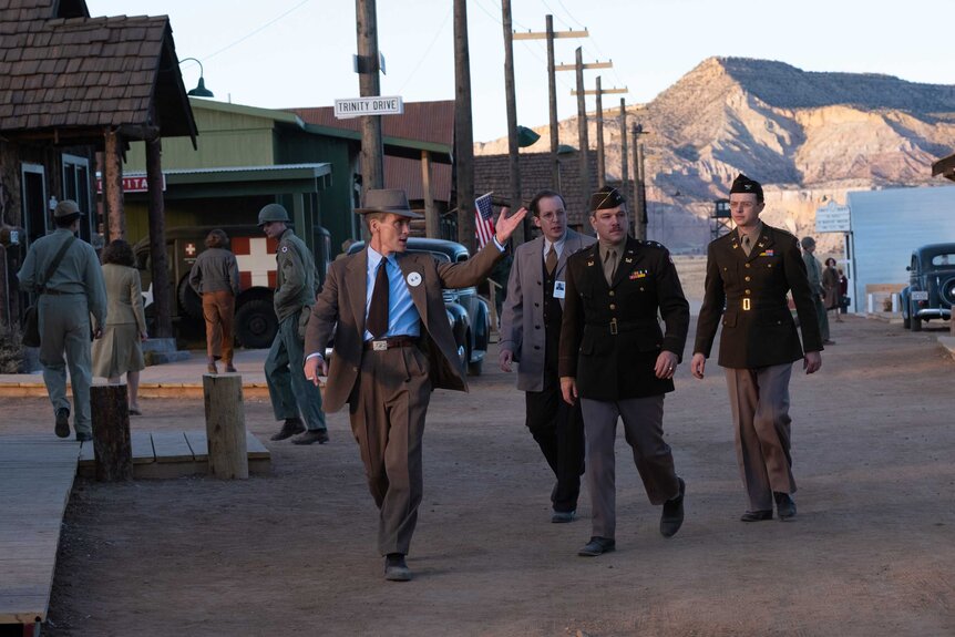 J. Robert Oppenheimer, Edward Condon, Leslie Groves, and Kenneth Nichols during a scene in Oppenheimer.