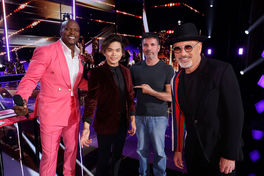 Americas Got Talent's Shin Lim stands backstage with Terry Crews, Simon Cowell, and Howie Mandel
