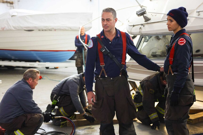 Randy “Mouch” McHolland, Kelly Severide, and Stella Kidd appear in a scene from Chicago Fire.