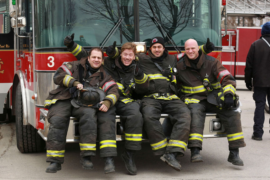 Ferraris, Hadley, Kelly Severide and Capp sit on a Fire Truck in Episode 121 of Chicago Fire