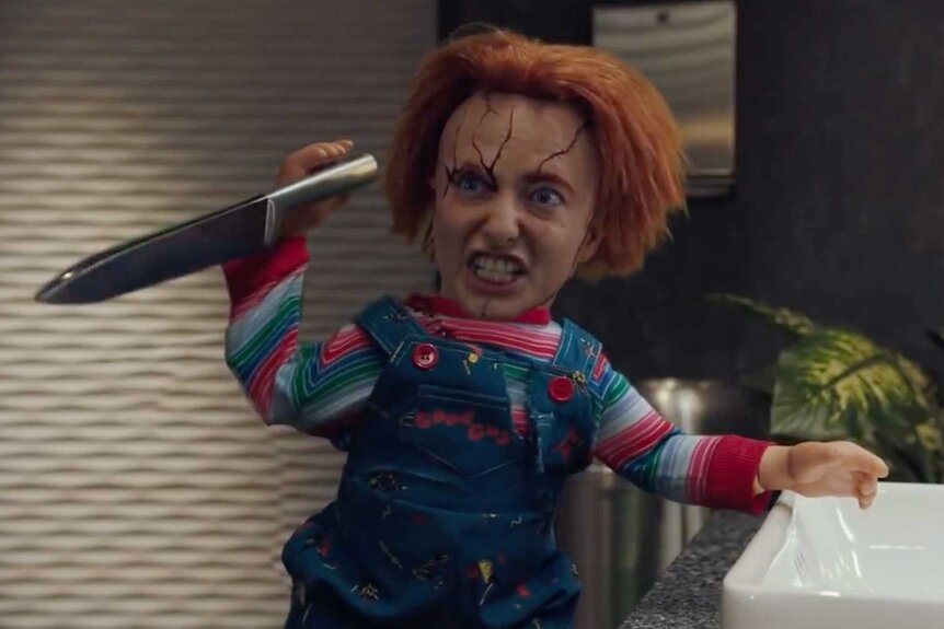 Sarah Sherman digitally altered as the character Chucky, holding a knife during the Chucky sketch on Saturday Night Live.