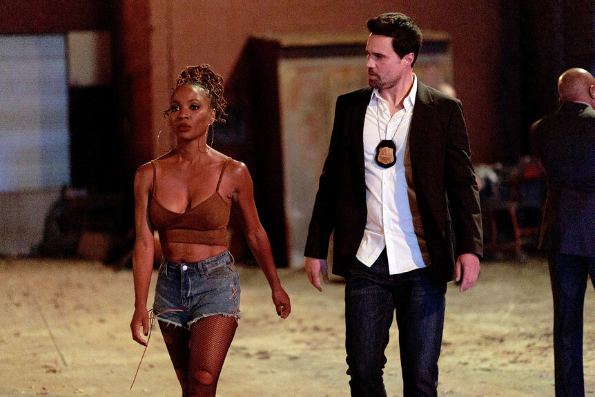 Shanola Hampton as Gabi Mosely and Brett Dalton as Detective Mark Trent walk together