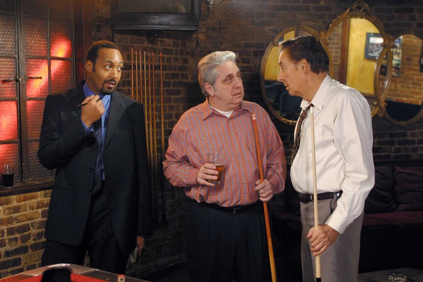 Detective Ed Green, Will Ashman, and Detective Lennie Briscoe playing pool and talking during a scene in Law & Order.