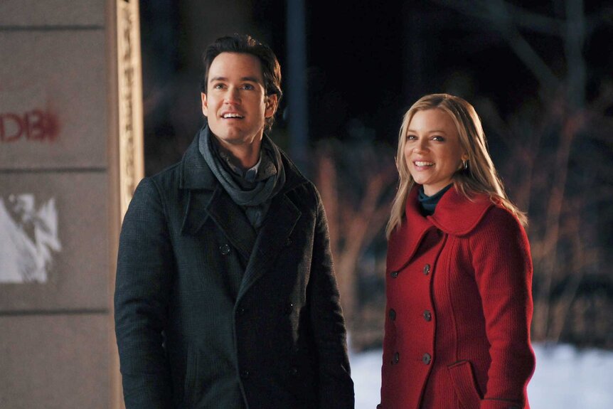 Miles and Kate appear together outside during a scene from 12 Dates of Christmas.
