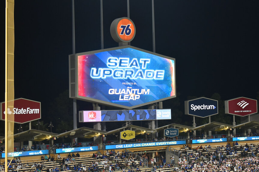 LA Dodgers arena screen with a colorful display that says "Seat Upgrade"