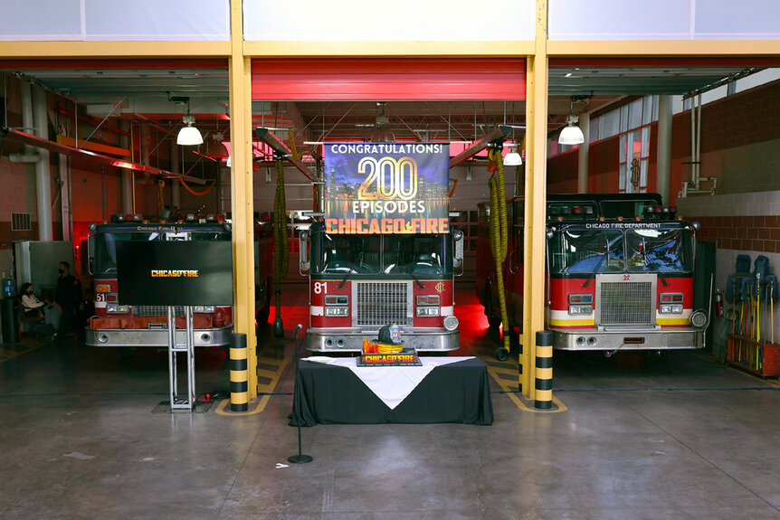 Three firetrucks parked inside a firehouse during Chicago Fire's 200th episode.