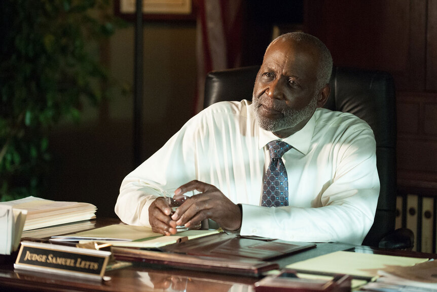 Letts (Richard Roundtree) sits behind a desk looking pensive