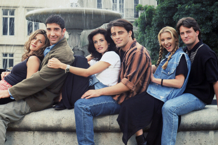 The Friends Cast pose in front of a water fountain for a friends promo shoot