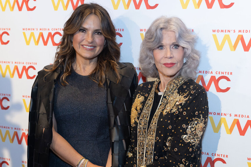 Mariska Hargitay and Jane Fonda stand closely in front of a step and repeat