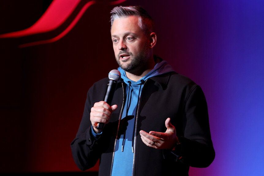 Nate Bargatze stands on stage during his comedy set