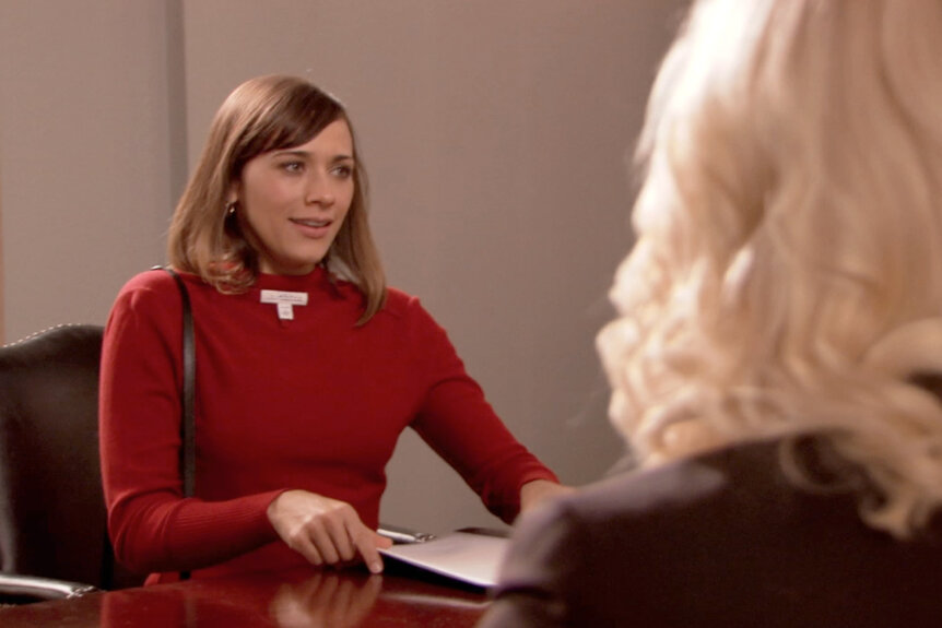 Ann Perkins talking to Leslie wearing a sweater backwards on Parks and Recreation