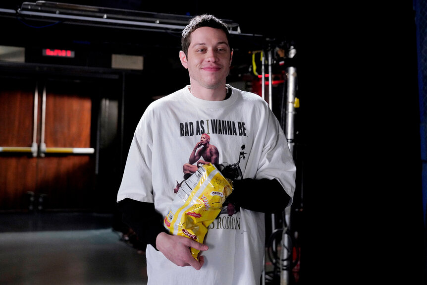 Pete Davidson eating potato chips on a promo for hosting SNL