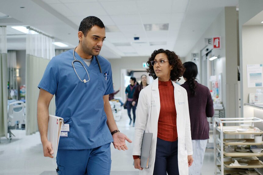 Dr. Bashir Hamed and Dr. Neeta Devi walking together in a emergency room.