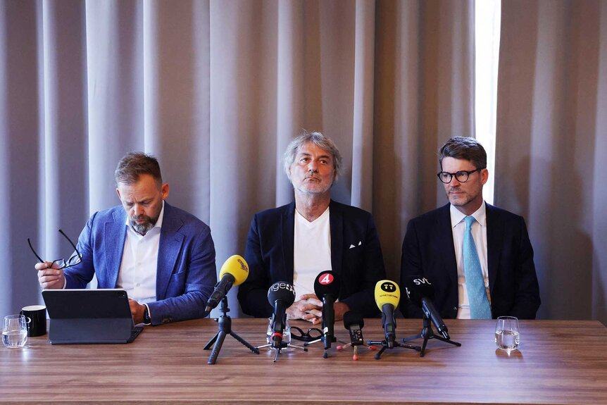 Dr. Paolo Macchiarini sitting with his Defense Attorney's during a press conference.