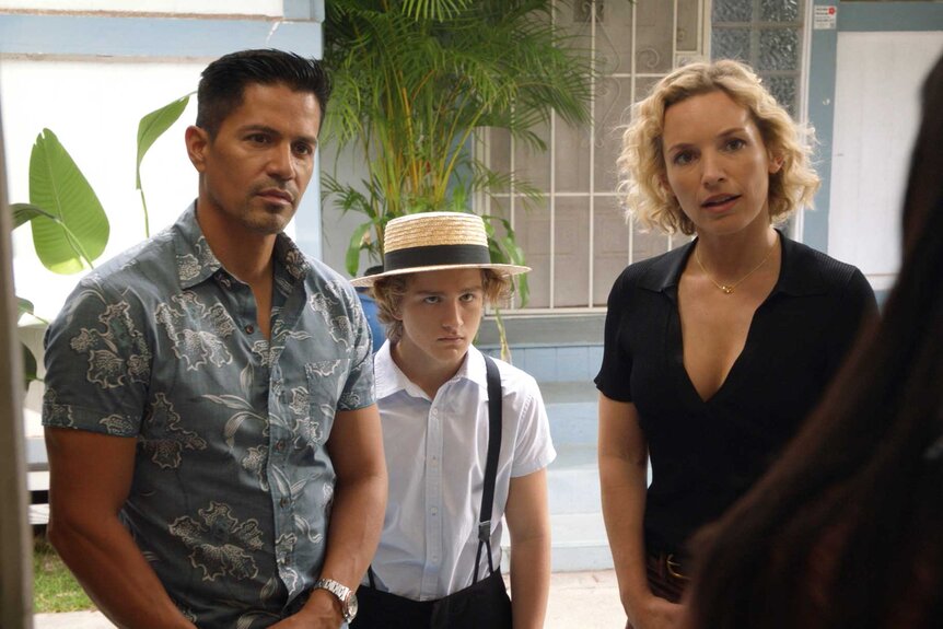 Thomas Magnum, Jacob, and Juliet Higgins standing next to each other and looking at another character.