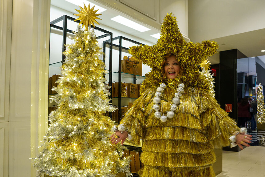 Melissa McCarthy dressed up in gold tinsel to resemble a Christmas tree in a scene from the new movie GENIE