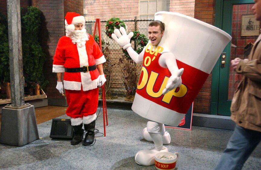 Will Forte dressed as Santa and Justin Timberlake dressed in a large cup suit during Saturday Night Live.