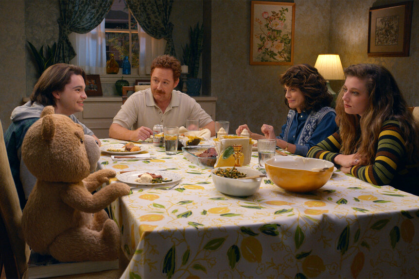 The cast of Ted sit around a dinner table on Ted Episode 1