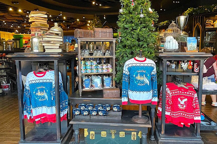 Blue and white Christmas sweaters displayed inside the Universal Studio Store.