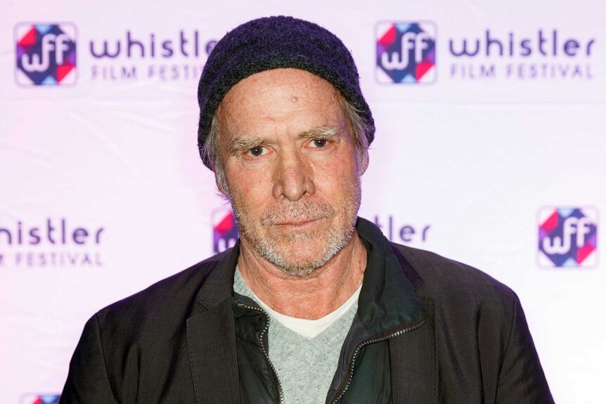 A close up of Will Patton posing at an event.