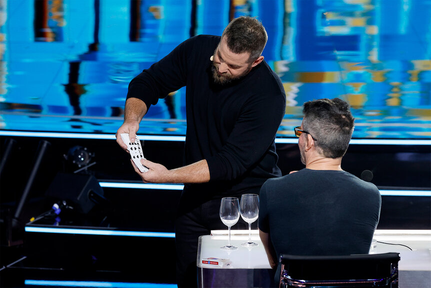 Jon Dorenbos shows Simon Cowel a card trick on America's Got Talent: Fantasy League Episode 101