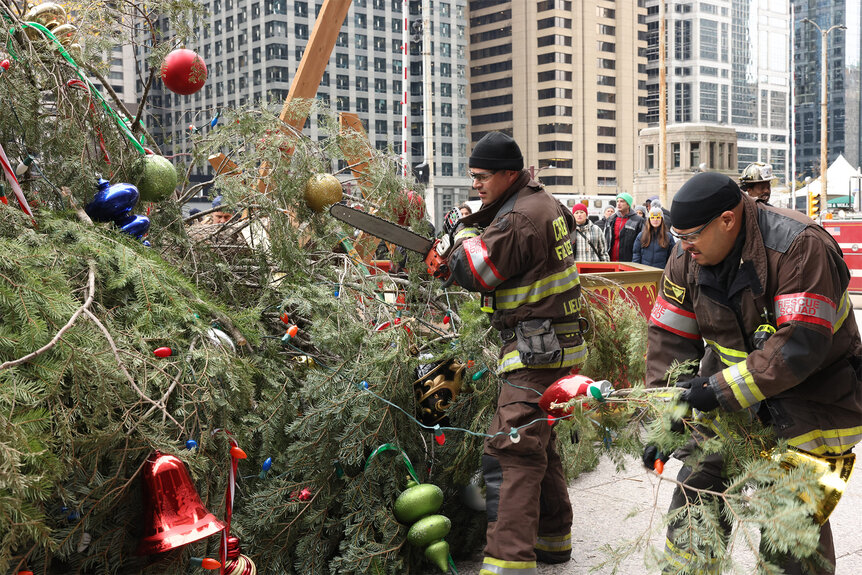 Kelly Severide and Joe Cruz cut a christmas tree with a chain saw on Chicago Fire Episode 1009
