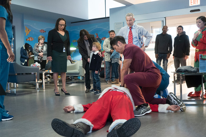Sharon Goodwin Dr. Stohl watch as Ethan Choi resuscitates a man in a santa suit