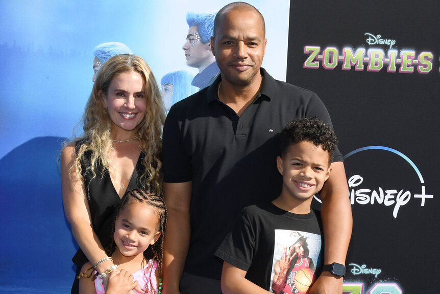 Donald Faison, Cacee Cobb and their two children pose for a photo at a premiere