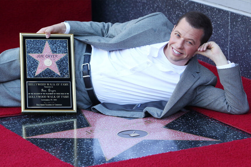 Jon Cryer lays on the floor at his star ceremony