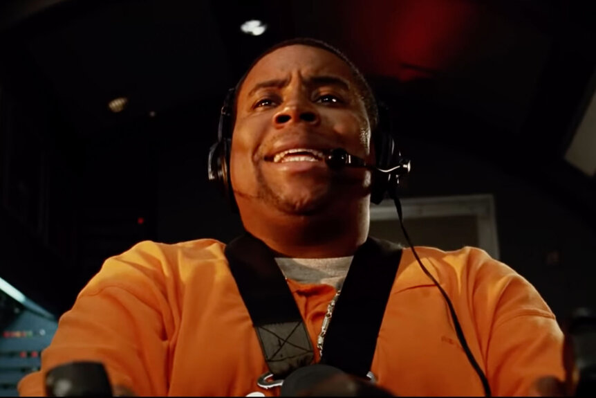 Close up of Kenan Thompson flying a plane in a movie