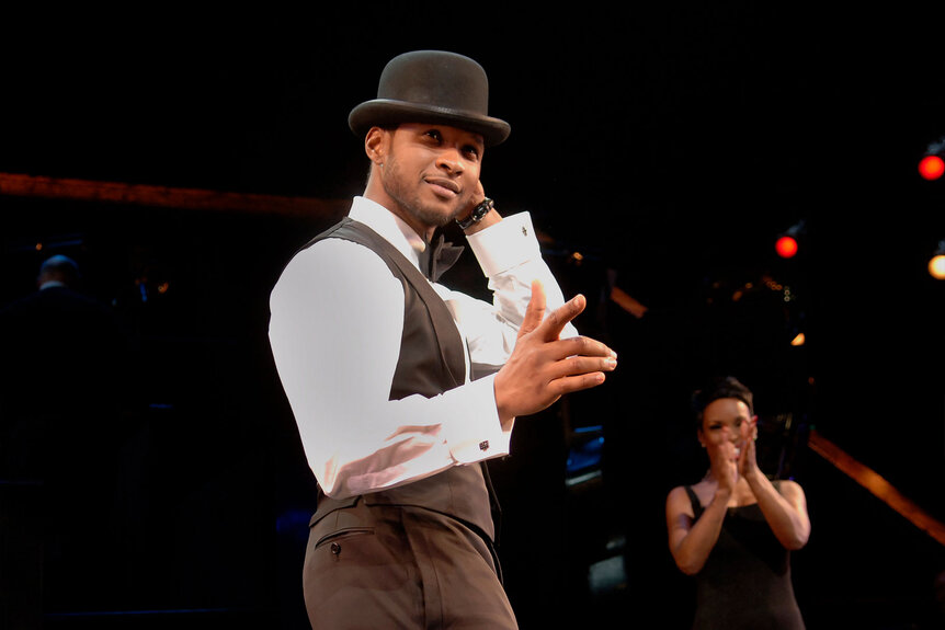 Usher onstage during his premiere on Broadway in "Chicago"