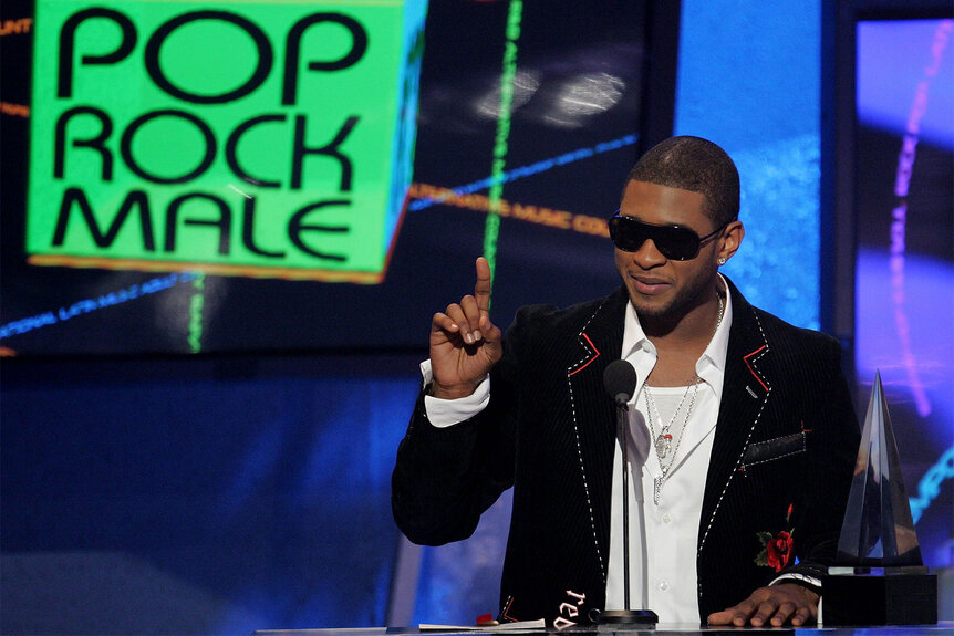 Usher accepts his award for "Favorite Male Artist - Pop/Rock" during the American Music Awards