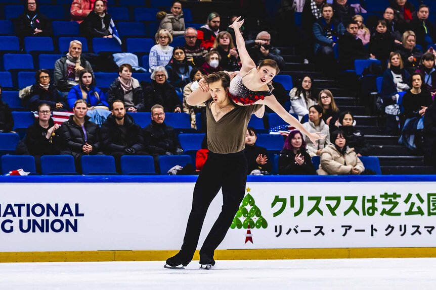 Anthony Ponomarenko lifts Christina Carreira while figure skating.