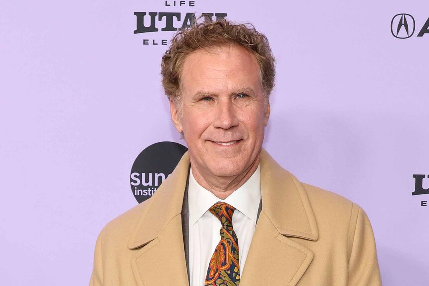 Will Ferrell smiles in a beige suit.