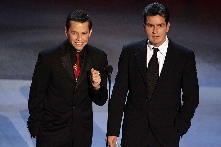 Jon Cryer and Charlie Sheen present an award onstage at the 57th Annual Emmy Awards