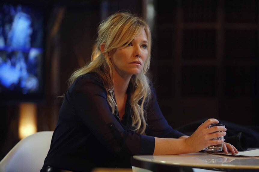 Det. Amanda Rollins (Kelli Giddish) rests on a table in Law & Order: Special Victims Unit 1517.