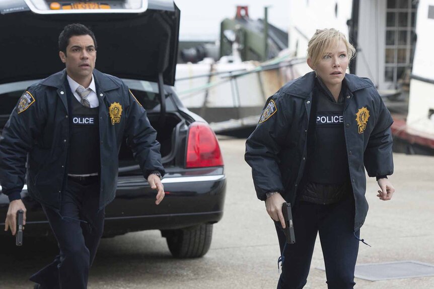 Det. Nick Amaro (Danny Pino) and Det. Amanda Rollins (Kelli Giddish) stand in front of an open car trunk in Law & Order: Special Victims Unit 1520