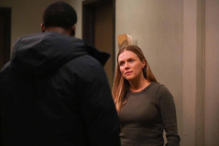 Hailey Upton looks up and talks to a man in Chicago P.D. Season 11 Episode 1.