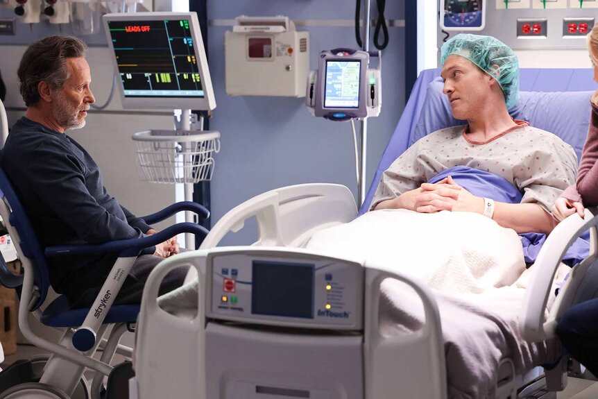 Dr. Dean Archer talks to Sean Archer in a hospital bed in Chicago Med Episode 902.