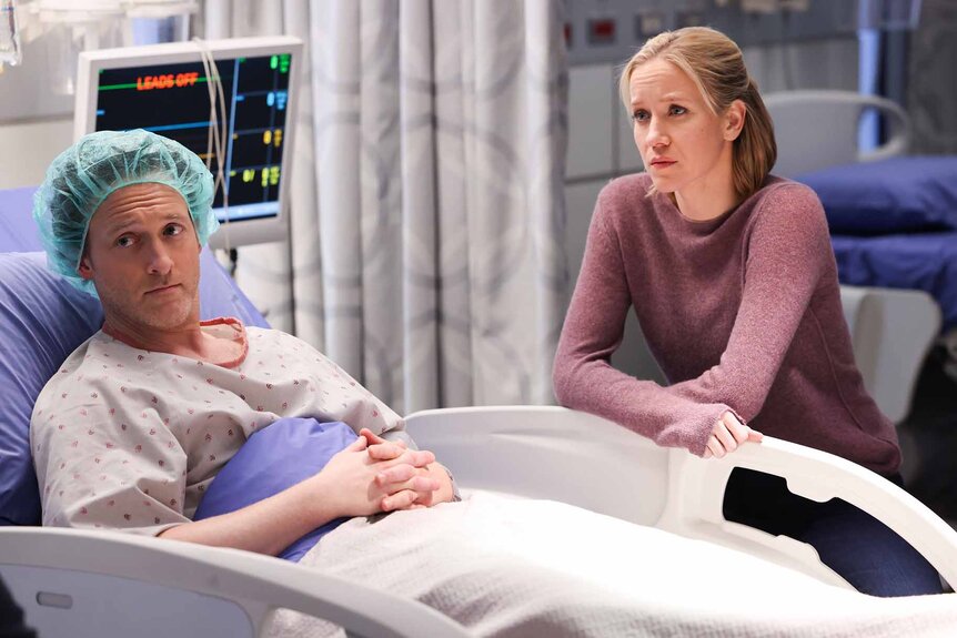 Dr. Hannah Asher looks at Sean Archer sitting in a hospital bed in Chicago Med Episode 902.