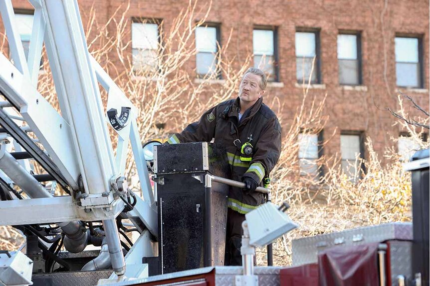 Randy McHolland sits in a lookout basket on a firefighting truck crane in Chicago Fire Episode 1202.