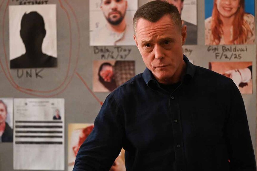 Hank Voight stands in front of an investigation board with photos in Chicago P.D. Episode 1102
